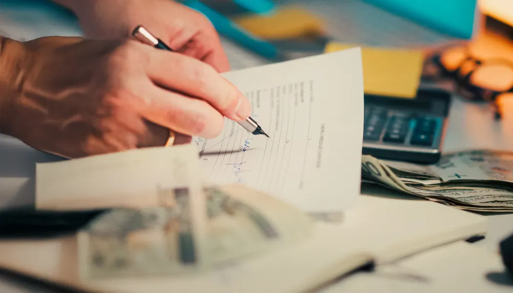 Card brand fee line items on a merchant statement being reviewed for markup.