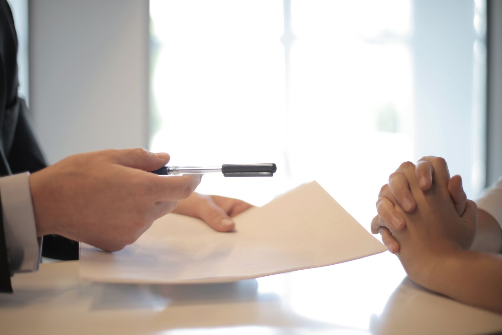 Business professional comparing financial documents with a client