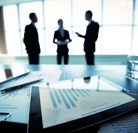 Professionals reviewing printed payment analysis materials